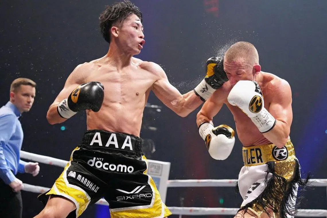 Naoya Inoue of Japan throws a punch at Paul Butler of Britain during their bantamweight title unification boxing match of WBA, WBC, IBF and WBO in Tokyo, Japan, December 13, 2022, in this photo released by Kyodo. Kyodo via REUTERS/File Photo