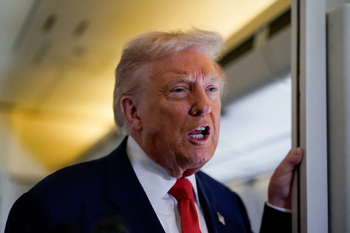 FILE PHOTO: U.S. President Donald Trump speaks to members of the media aboard Air Force One as he departs for Florida from Joint Base Andrews, Maryland, U.S., October 31, 2025. REUTERS/Elizabeth Frantz/File Photo