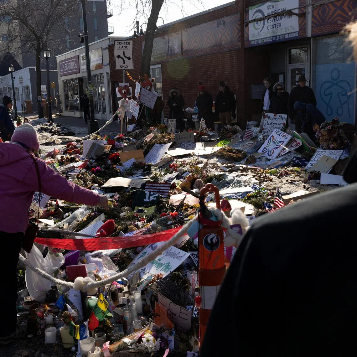 Signs and flowers are placed at the memorial site for Alex Pretti, following the fatal shootings of Pretti and Renee Nicole Good by U.S. federal immigration agents, in Minneapolis, Minnesota, U.S. February 8, 2026.  REUTERS/Go Nakamura