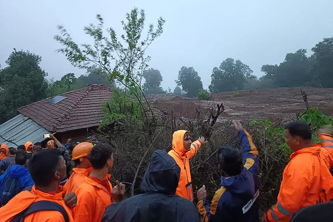India’s National Disaster Response Force personnel inspect the site of a landslide in Maharashtra state.  