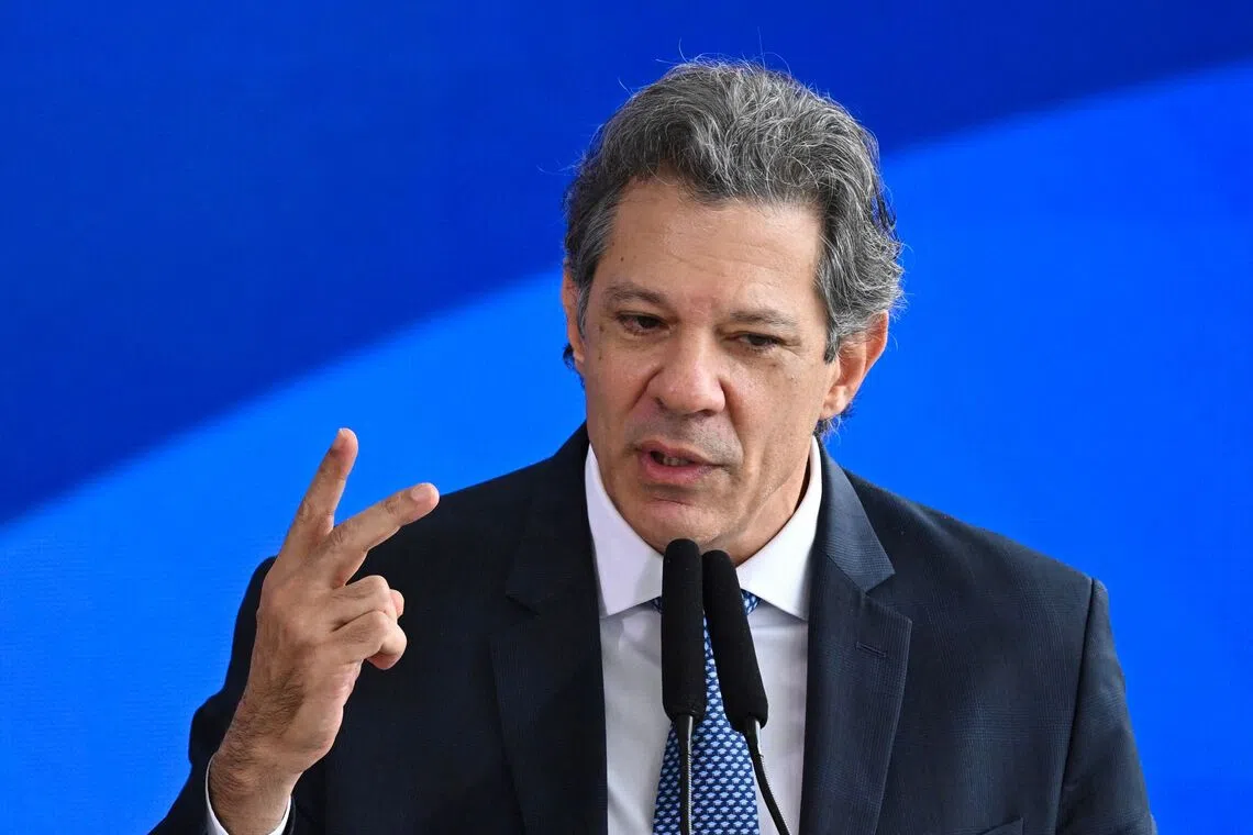 Brazil's Finance Minister Fernando Haddad gestures as he speaks during the signing ceremony of the new Income Tax Law at the Planalto Palace in Brasilia, on November 26, 2025. (Photo by Evaristo Sa / AFP)