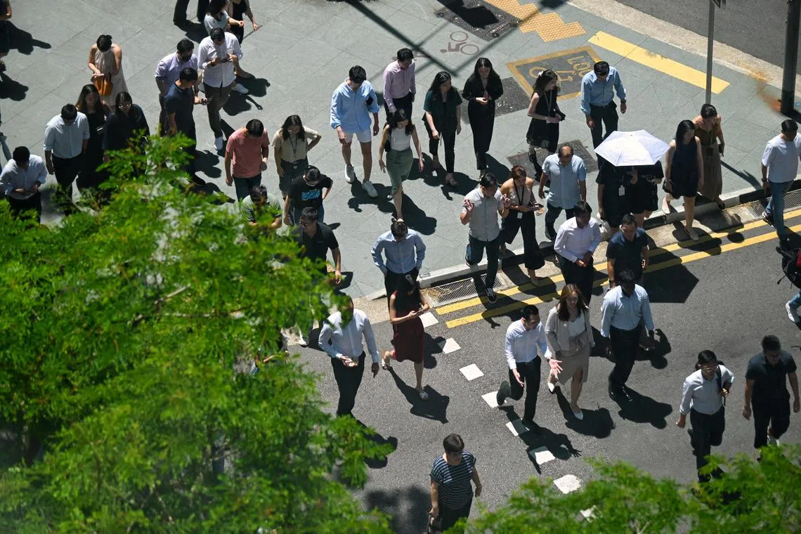 Pixgeneric / Generic pix of office workers, crossing a traffic junction along Church Street in the central business district (CBD), during lunch hour, under the hot noonday sun on May 9, 2024.