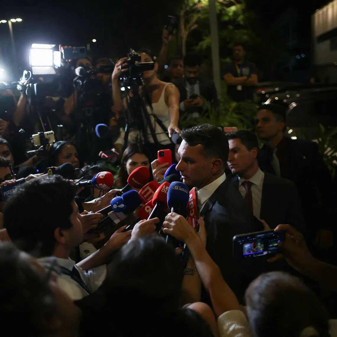 Senator Flavio Bolsonaro, son of former Brazilian President Jair Bolsonaro, speaks to the media outside the hospital where his father was taken after feeling sick, according to him, following his sentencing last week by a Supreme Court panel to 27 years and three months in prison for plotting a coup after losing the 2022 election, in Brasilia, Brazil, September 16, 2025. REUTERS/Adriano Machado