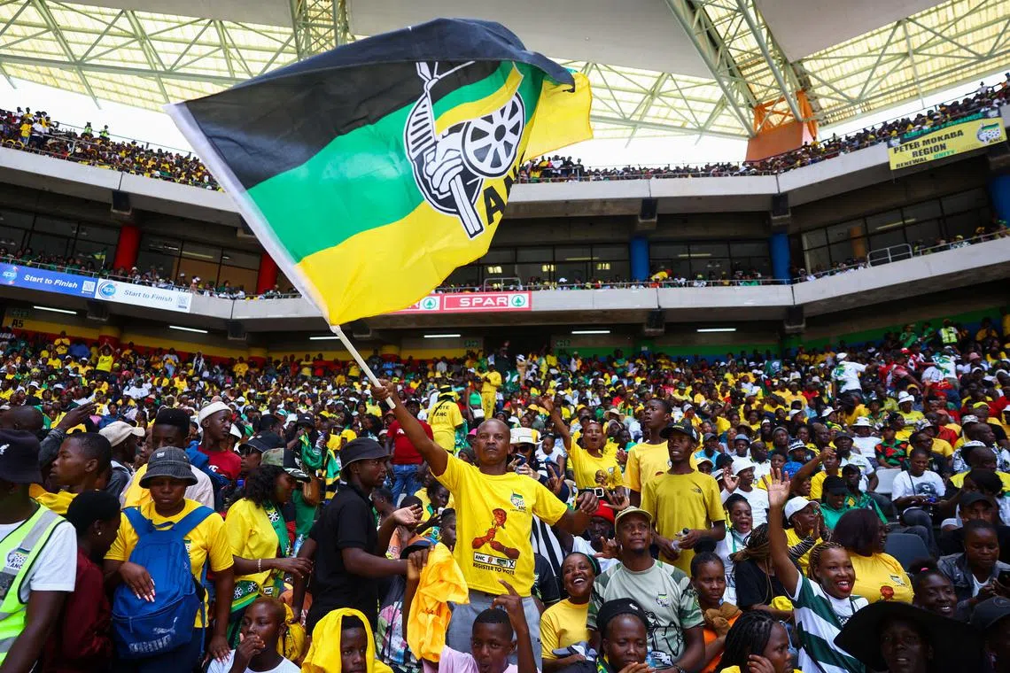 An African National Congress (ANC) supporter waves a flag during the 112th anniversary celebrations of the founding of the party, at Mbombela Stadium in Mpumalanga province, South Africa, January 13, 2024. REUTERS/Siphiwe Sibeko/File Photo