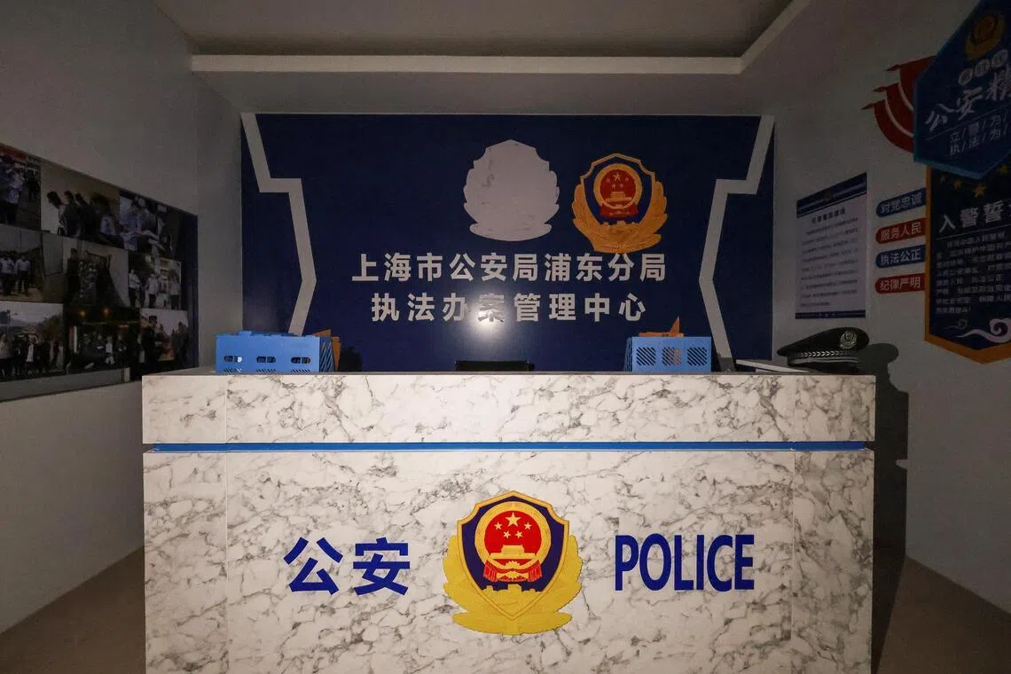 A room set up to imitate a China police station, inside a compound in O'Smach, Cambodia used for scam operations.