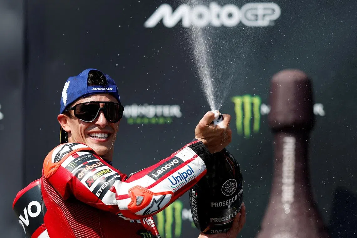 FILE PHOTO: MotoGP - Czech Republic Grand Prix - Masaryk Circuit, Brno, Czech Republic - June 21, 2026 Ducati Lenovo Team's Marc Marquez sprays champagne out of the bottle after winning the race REUTERS/David W Cerny/File Photo