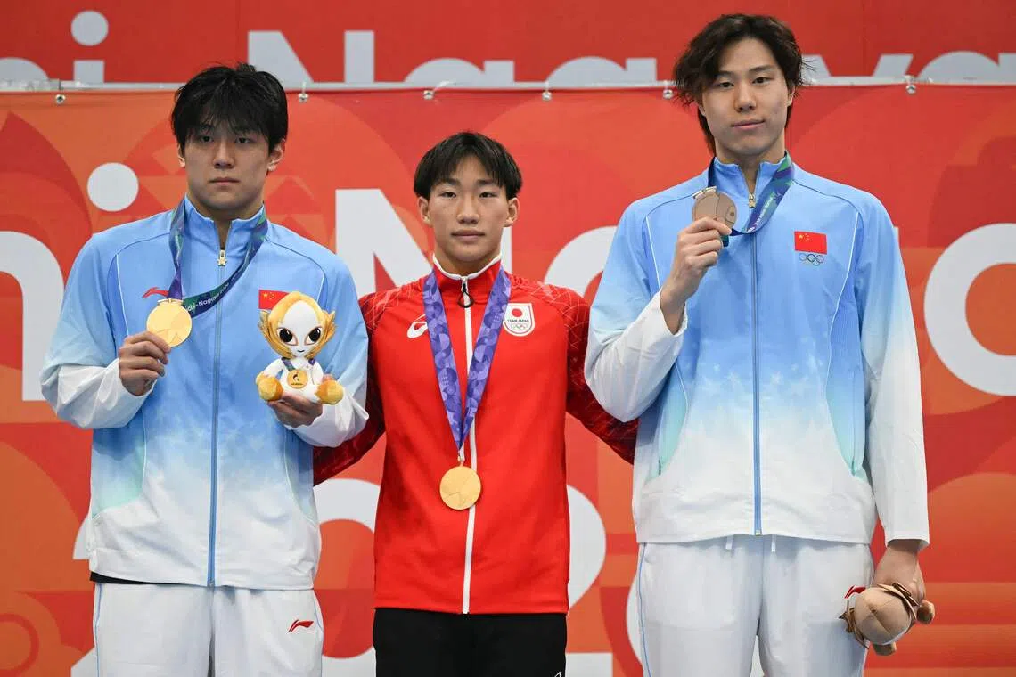 Japan’s Shin Ohashi (centre) shared the men’s 100m breaststroke gold with China’s Dong Zhihao (left), while Qin Haiyang settled for bronze.