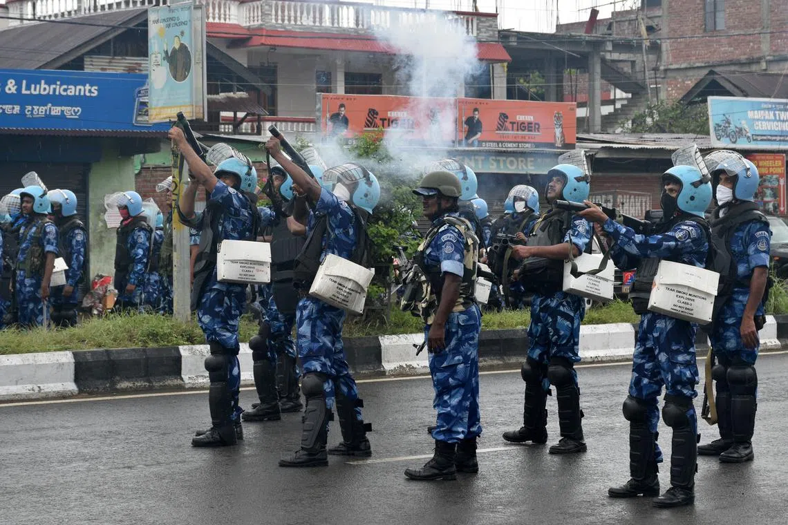 FILE PHOTO: Riot police officers fire tear smoke shells to disperse demonstrators protesting against the arrest of five people, who police said were carrying weapons while wearing camouflage uniform, in Imphal, Manipur, India, September 18, 2023. REUTERS/Stringer/File Photo
