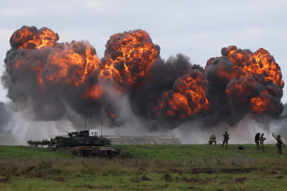 FILE PHOTO: Smoke billows from a blast near Polish Abrams tank as Polish forces with NATO soldiers hold military exercises 'Iron Defender' at a military range in Wierzbiny near Orzysz, Poland, September17, 2025. REUTERS/Kacper Pempel/File Photo