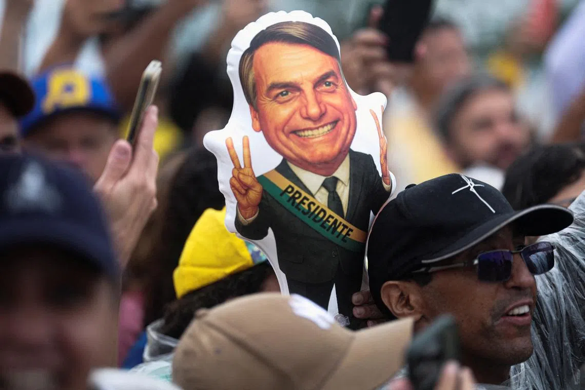 FILE PHOTO: A depiction of former Brazilian President Jair Bolsonaro is held by a protester during a demonstration following a march entitled \"Walk for Freedom and Justice,\" led by opposition congressman Nikolas Ferreira, as participants arrive in Brasilia after a 240‑km walk from Paracatu to protest in support of Bolsonaro, who is serving a 27‑year sentence for plotting a coup, in Brasilia, Brazil, January 25, 2026. REUTERS/Mateus Bonomi/File Photo