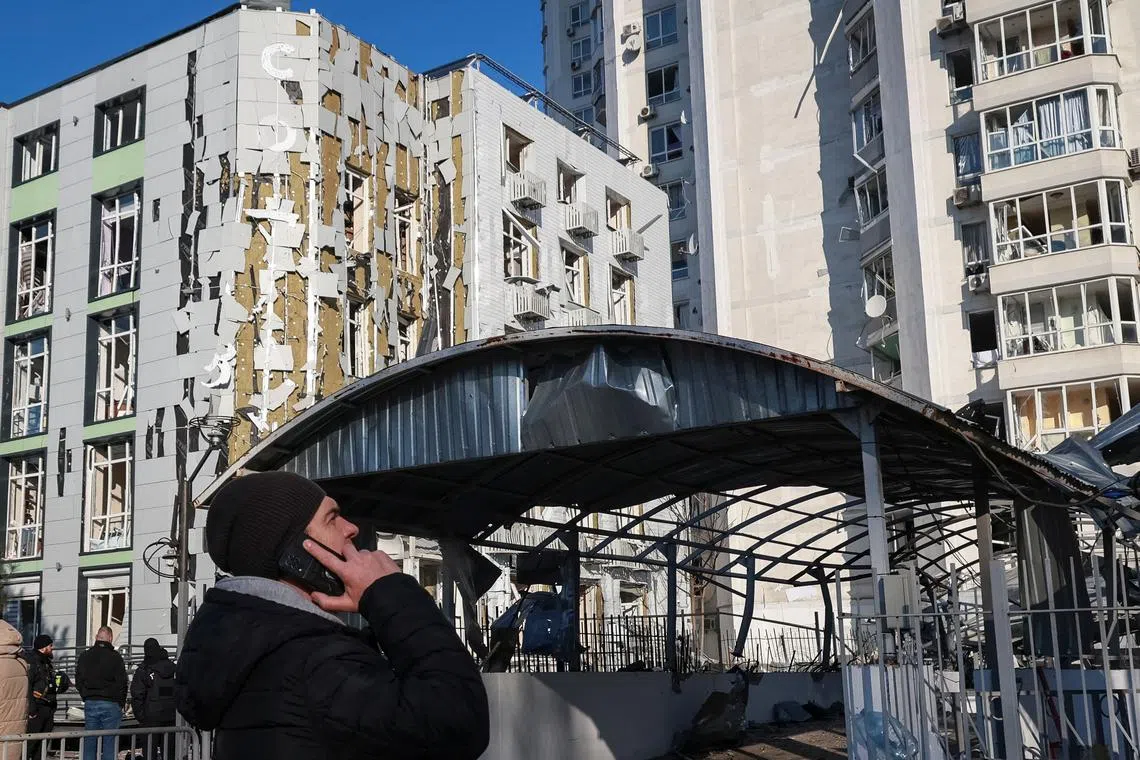 FILE PHOTO: A resident stands at the site of an apartment building and a clinic hit by a Russian drone strike, amid Russia's attack on Ukraine, in Odesa, Ukraine February 19, 2025. REUTERS/Nina Liashonok/File Photo