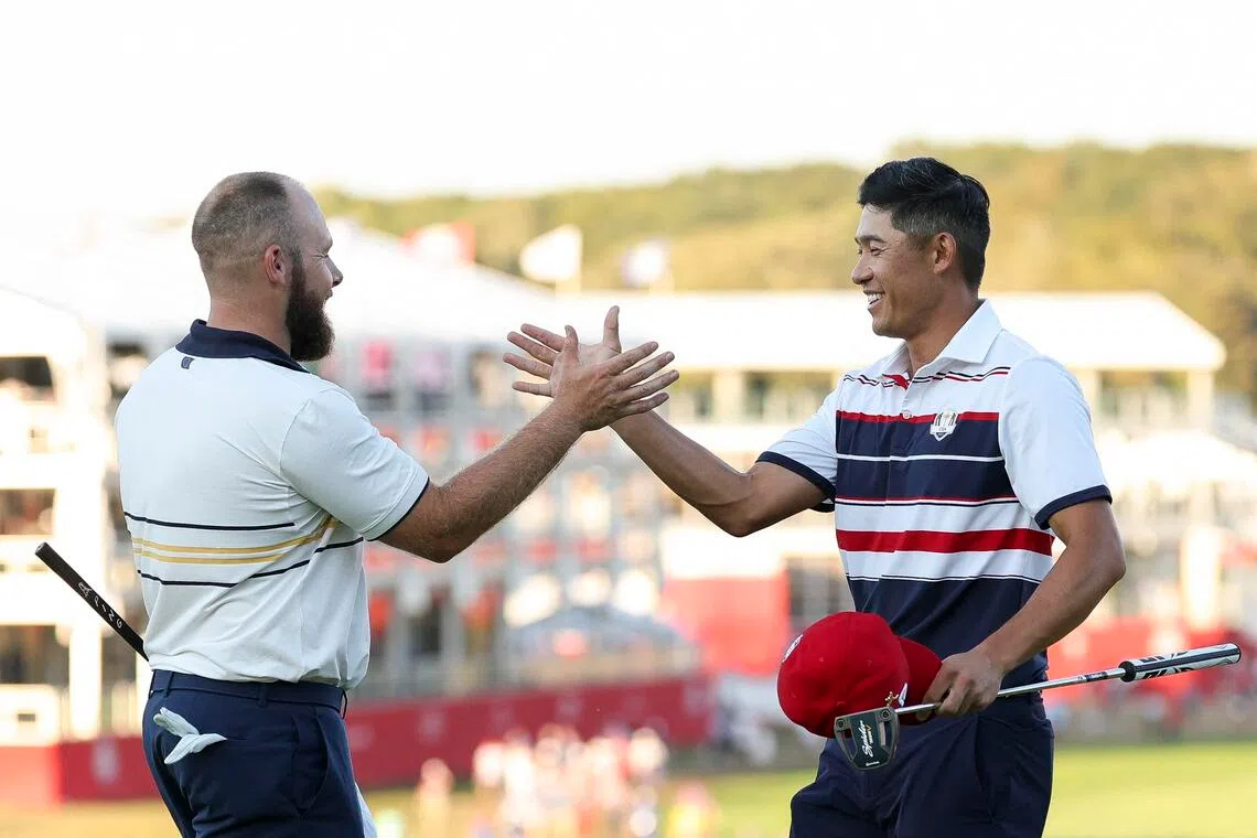 Tyrrell Hatton (left) of Team Europe and Collin Morikawa of Team United States clasping hands after their match during the Sunday singles matches of the 2025 Ryder Cup at Black Course at Bethpage State Park Golf Course on Sept 28, 2025 in Farmingdale, New York. 