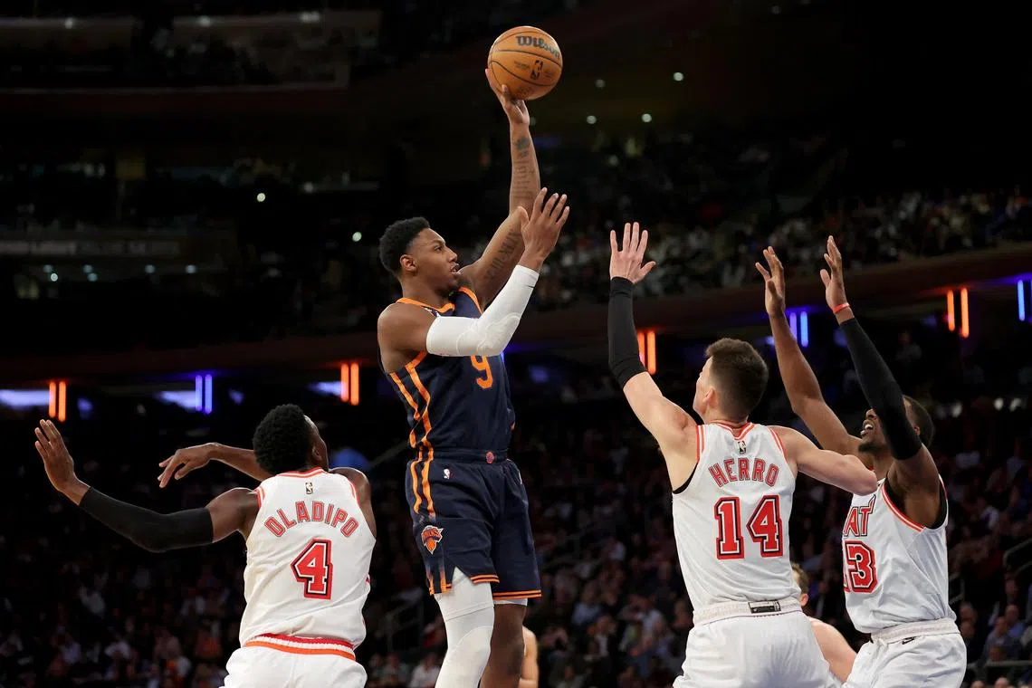 New York Knicks guard RJ Barrett shooting over Miami Heat's Victor Oladipo, Tyler Herro and centre Bam Adebayo during the fourth quarter at Madison Square Garden. 