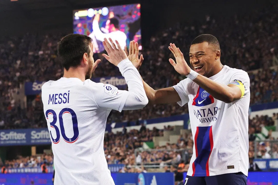 Paris Saint Germain's Lionel Messi (left) celebrates with teammate Kylian Mbappe after scoring.