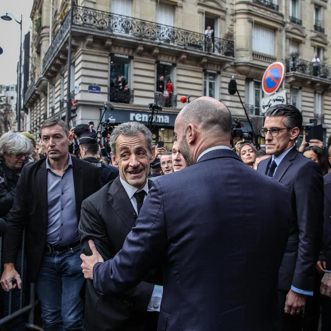 Former French president Nicolas Sarkozy arrives to sign copies of his book at the Lamartine bookshop in Paris.