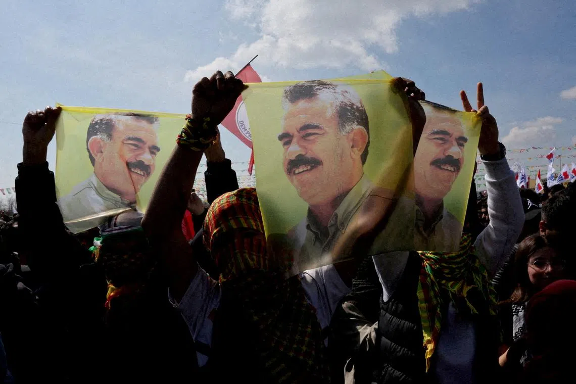 FILE PHOTO: Supporters of the pro-Kurdish Peoples' Equality and Democracy Party (DEM Party) display flags with a portrait of jailed Kurdistan Workers Party (PKK) leader Abdullah Ocalan, in Istanbul, Turkey, March 17, 2024. REUTERS/Umit Bektas/File Photo