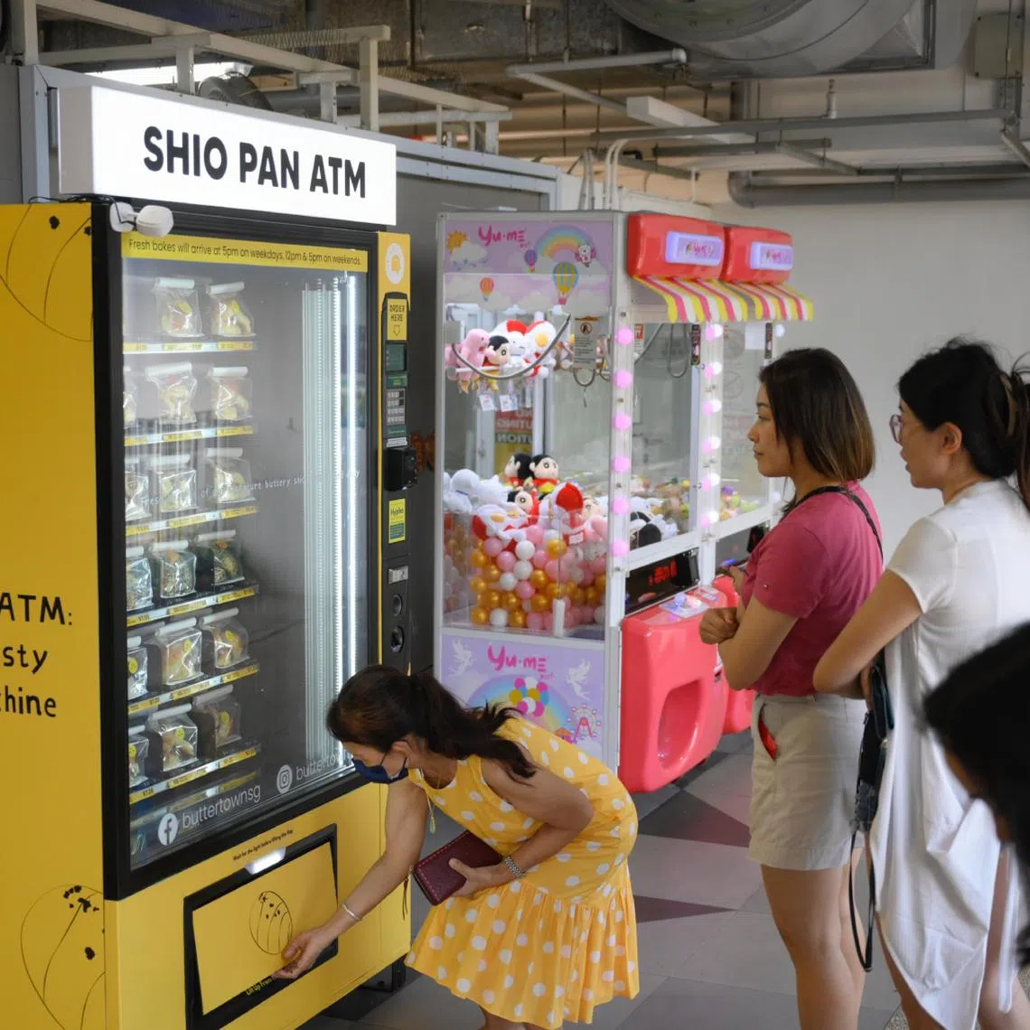 Customers queue to buy shio pan from Butter Town bakery's shio pan "ATM" at Woodleigh Village Hawker Centre.
