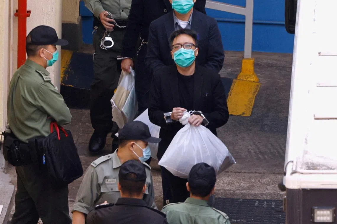 FILE PHOTO: Pro-democracy activist Tam Tak-chi walks to a prison van to head to court, over national security law charges, in Hong Kong, China March 2, 2021. REUTERS/Tyrone Siu/ File Photo