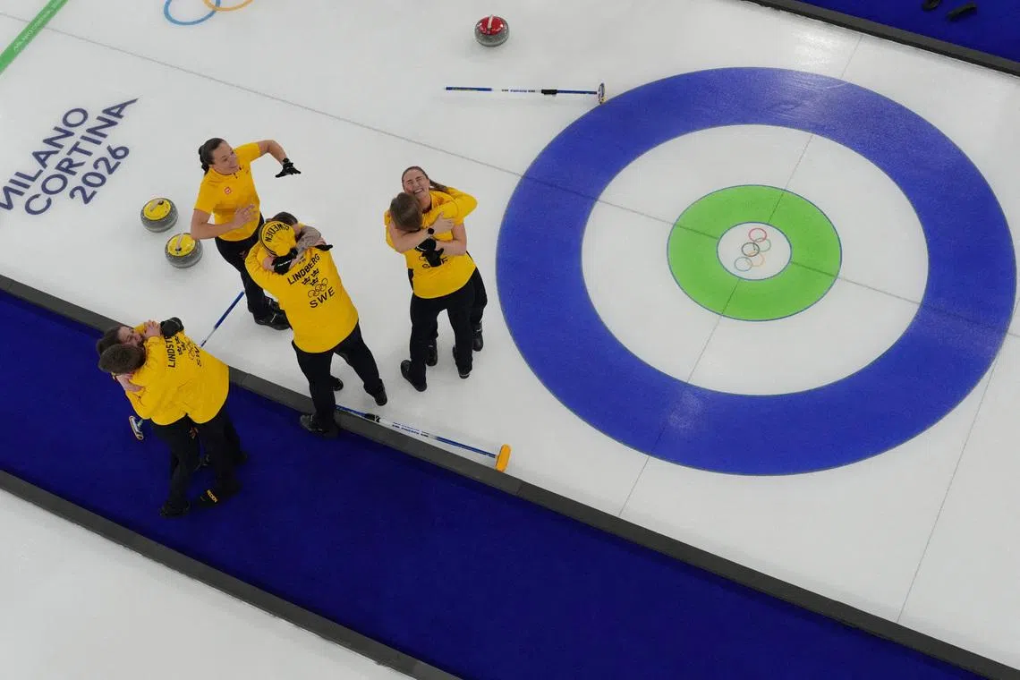 Milano Cortina 2026 Olympics - Curling - Women's Gold Medal Game - Switzerland vs Sweden - Cortina Curling Olympic Stadium, Cortina d'Ampezzo, Italy - February 22, 2026.  Team Sweden celebrates winning gold in the Women's Curling REUTERS/Jennifer Lorenzini