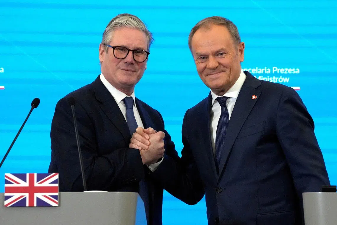 Britain's Prime Minister Keir Starmer and Polish Prime Minister Donald Tusk shake hands after a press conference in Warsaw, Poland, January 17, 2025. Czarek Sokolowski/Pool via REUTERS/File Photo