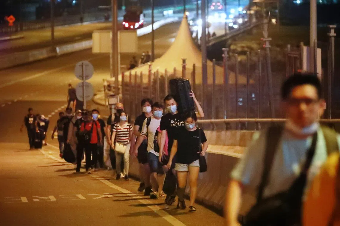 People walking across the Causeway to Johor Bahru after the land borders between Singapore and Malaysia fully reopened at midnight on April 1, 2022.