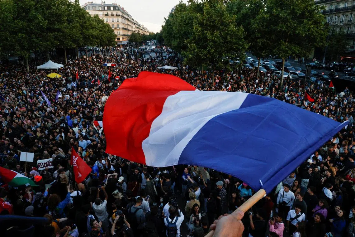 A protester holds a French flag in Paris, France, on July 7, 2024.