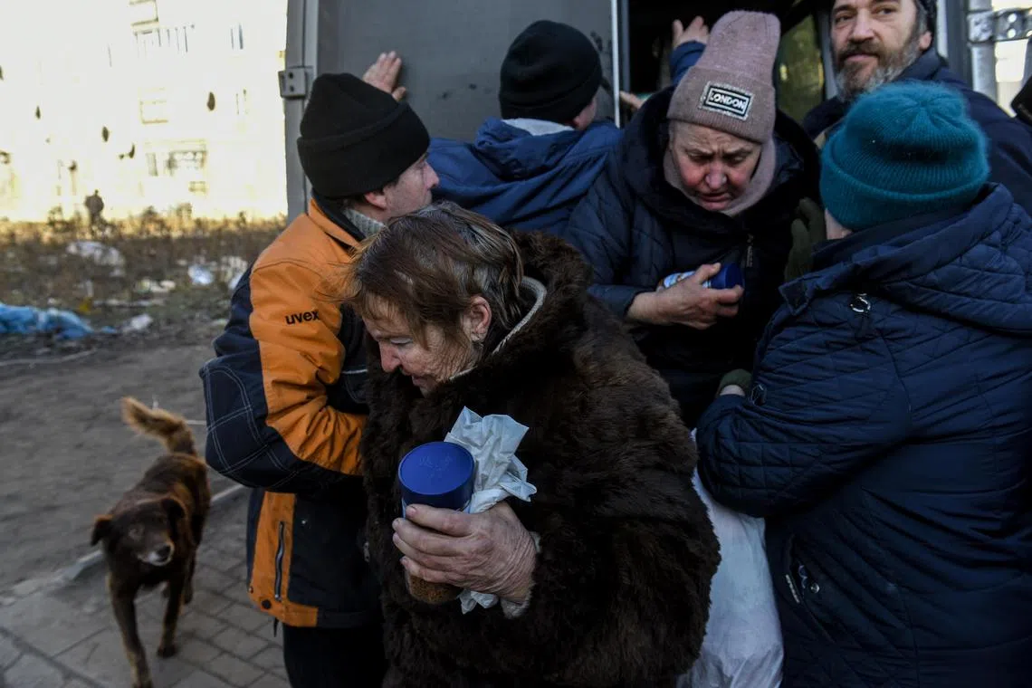 Residents receiving humanitarian aid in Bakhmut, Donetsk region, eastern Ukraine, on Jan 24, 2023. 