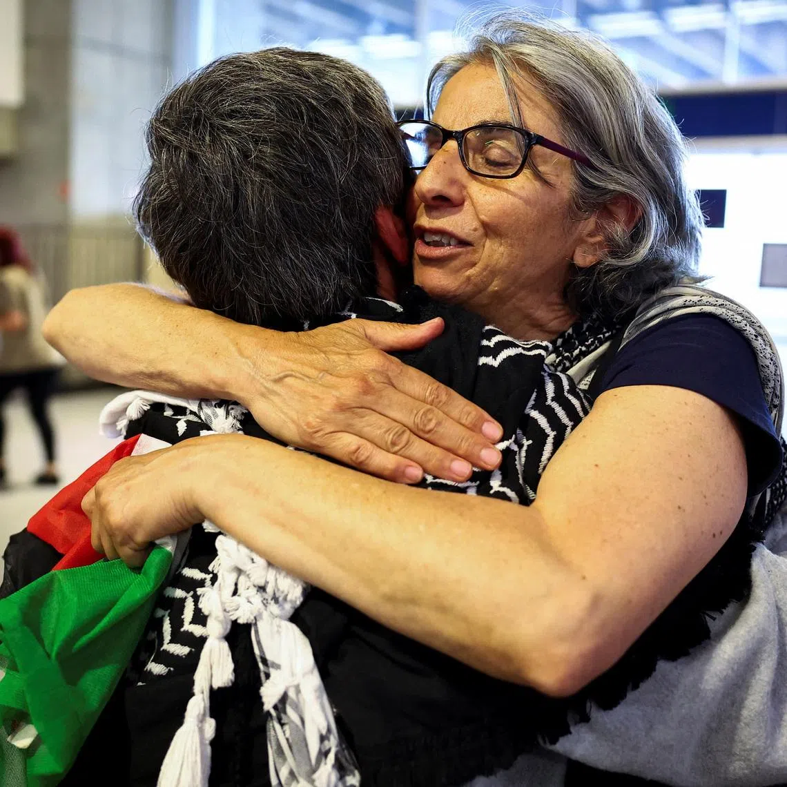 French activists from the Gaza-bound Global Sumud Flotilla, detained by Israeli forces after their vessels were intercepted in international waters in the Mediterranean, arrive at Charles de Gaulle Airport, in Roissy-en-France, near Paris, France May 22, 2026. REUTERS/Abdul Saboor