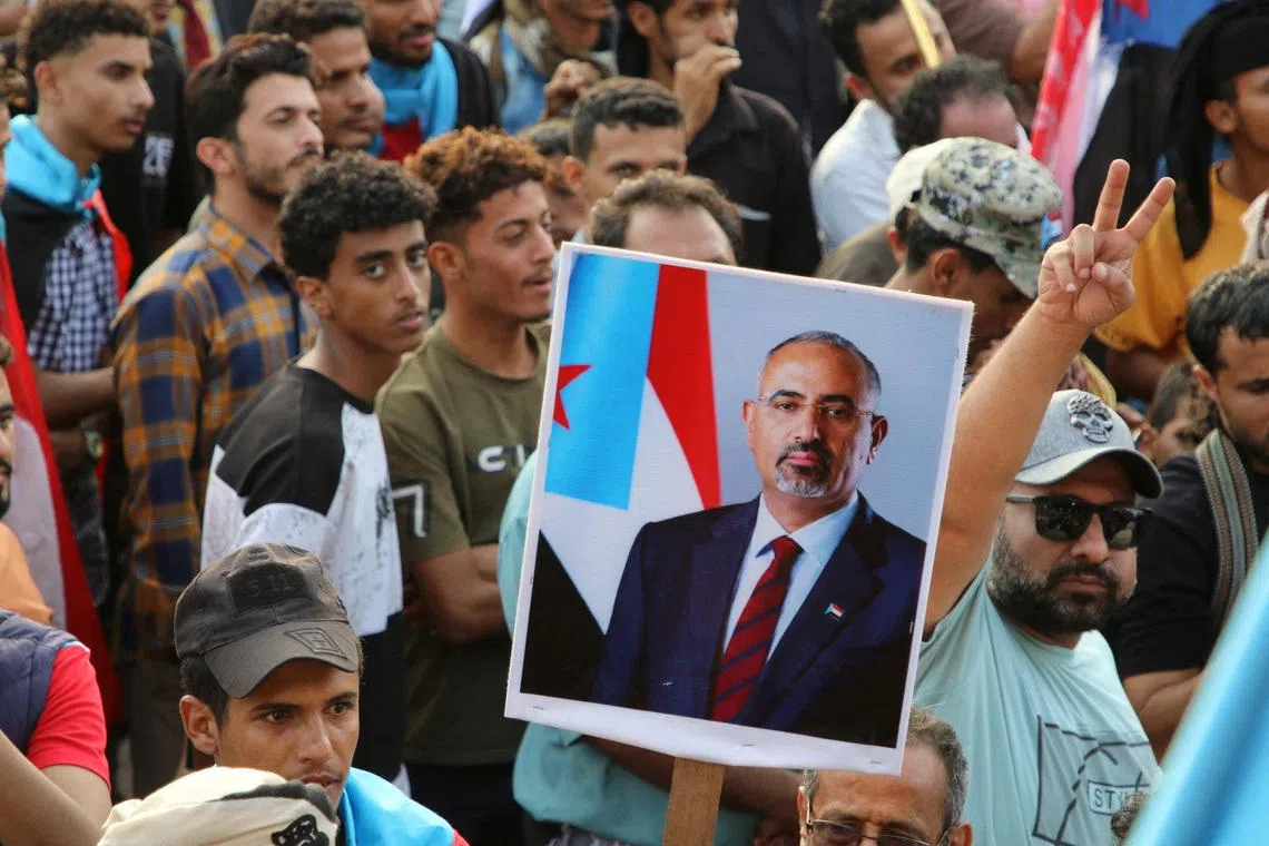 FILE PHOTO: Supporters of the UAE-backed separatist Southern Transitional Council (STC) hold a poster of Aidarous al-Zubaidi, the STC's leader, who, according to the Saudi-backed coalition, fled to an unknown destination, in Aden, Yemen, December 21, 2025. REUTERS/Fawaz Salman/File Photo