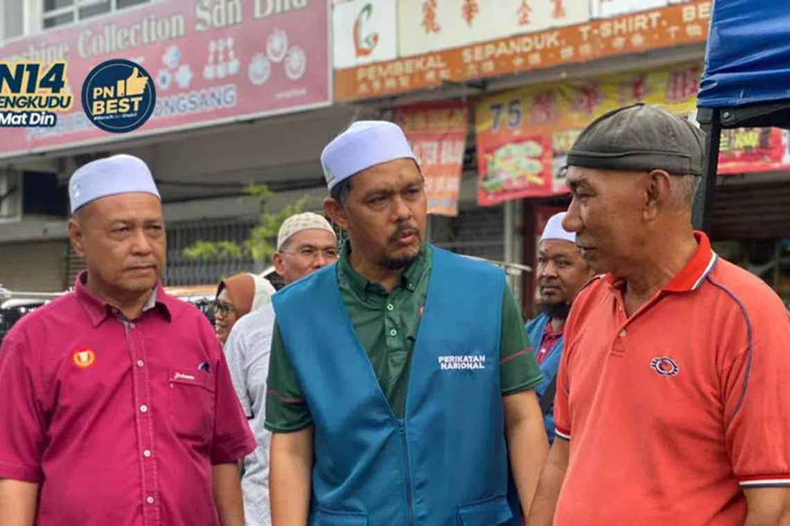 Former skipper of Kedah state's football team, Radhi Mat Din, 58 (centre) is one of two ex-footballers running in the Aug 12 polls.