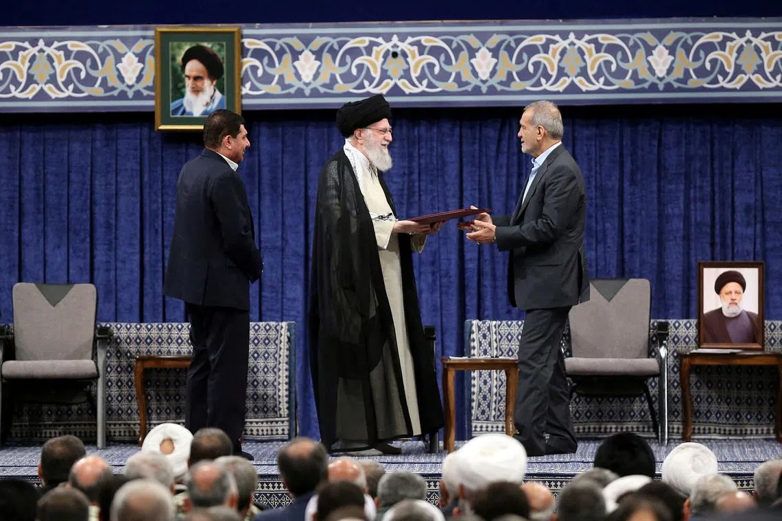 Iran's Supreme Leader Ayatollah Ali Khamenei gives a Presidential decree to Iran's new president, Masoud Pezeshkian, during an endorsement ceremony in Tehran, Iran, July 28, 2024. Office of the Iranian Supreme Leader/WANA (West Asia News Agency)/Handout via REUTERS