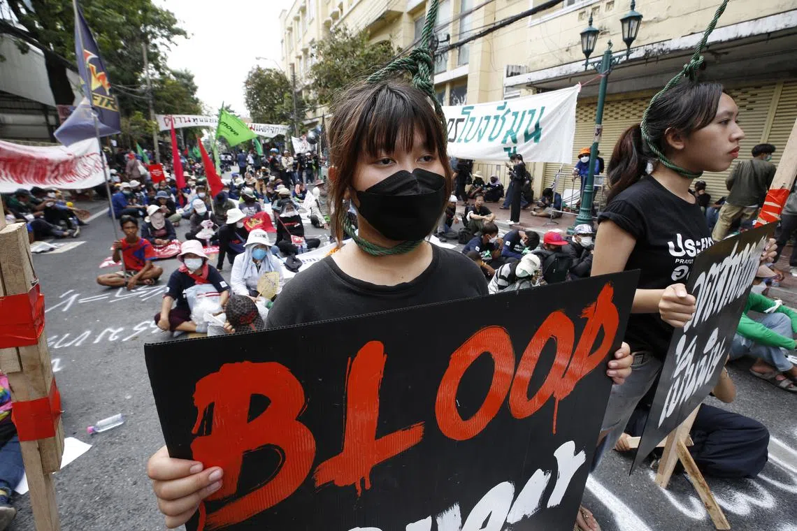epa10312039 Anti-government protesters hold placards while wearing nooses around their necks during a protest against the APEC 2022 summit in Bangkok, Thailand, 18 November 2022. Anti-government protesters held a demonstration calling for the resignation of Thai Prime Minister Prayut Chan-o-cha as Thailand hosts the Asia-Pacific Economic Cooperation or APEC 2022, the summit for economic cooperation comprising 21 leading member economies.  EPA-EFE/NARONG SANGNAK