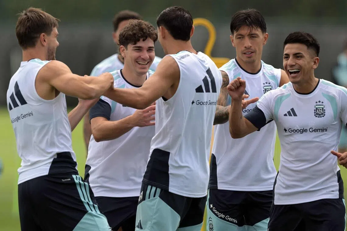 Argentina’s forward Julian Alvarez (second from left) shares a laugh with teammates during a training session in Kansas City on June 13.