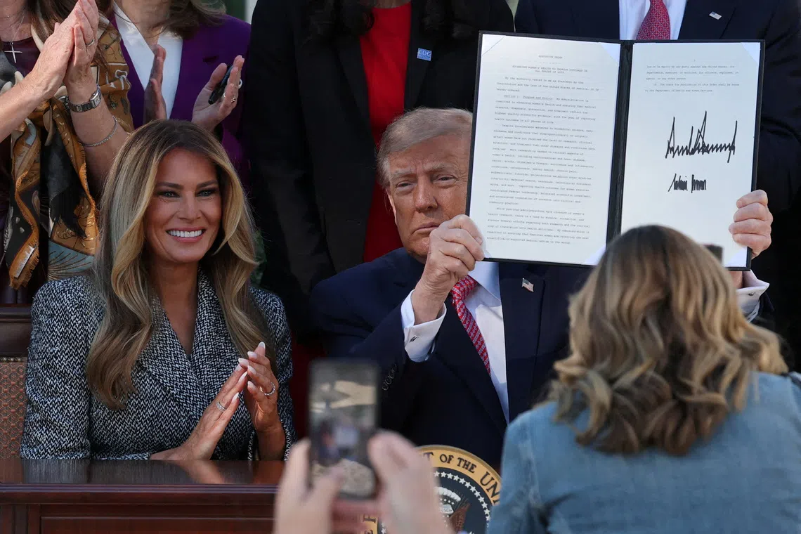 US President Donald Trump presents an executive order on women’s health, spearheaded by first lady Melania Trump, at the White House in Washington DC.