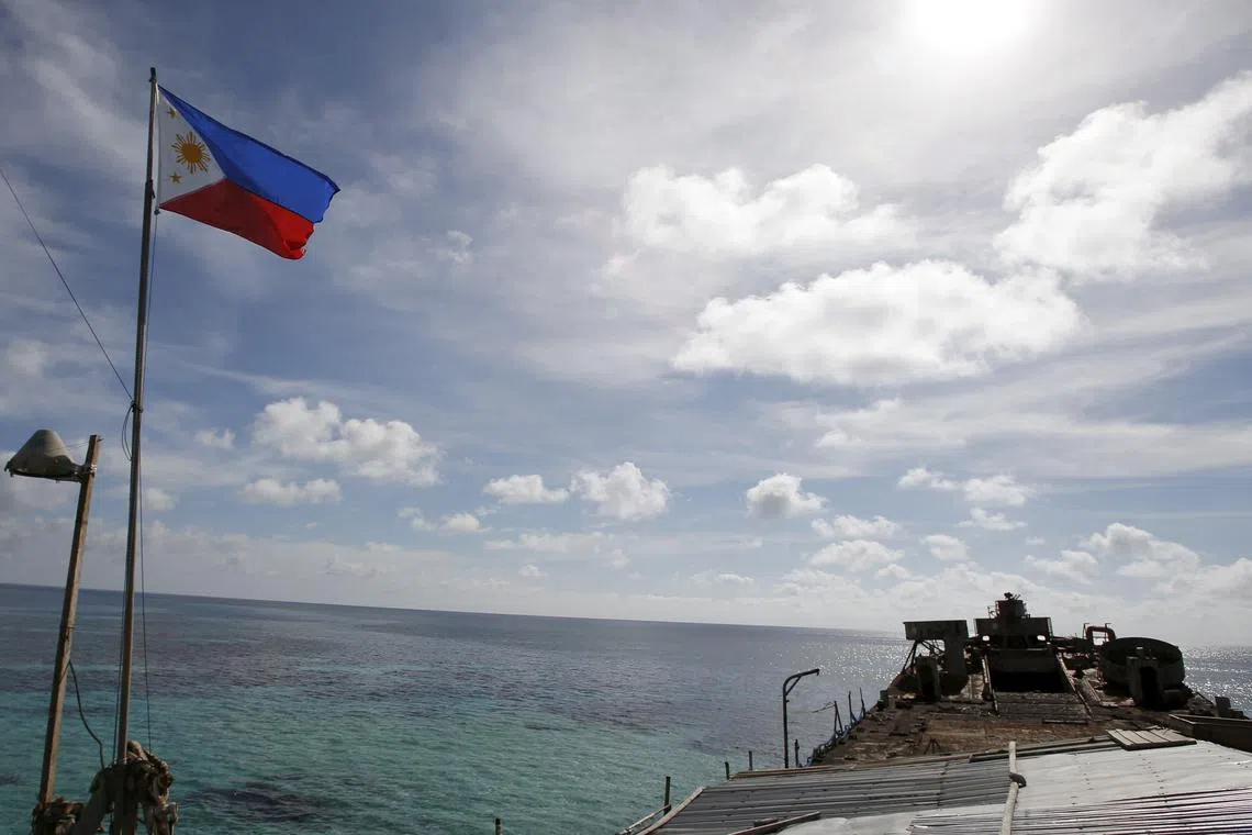 FILE PHOTO: A Philippine flutters on BRP Sierra Madre, a dilapidated Philippine Navy ship that has been aground since 1999, on the disputed Second Thomas Shoal, part of the Spratly Islands, in the South China Sea March 29, 2014.  REUTERS/Erik De Castro/File Photo