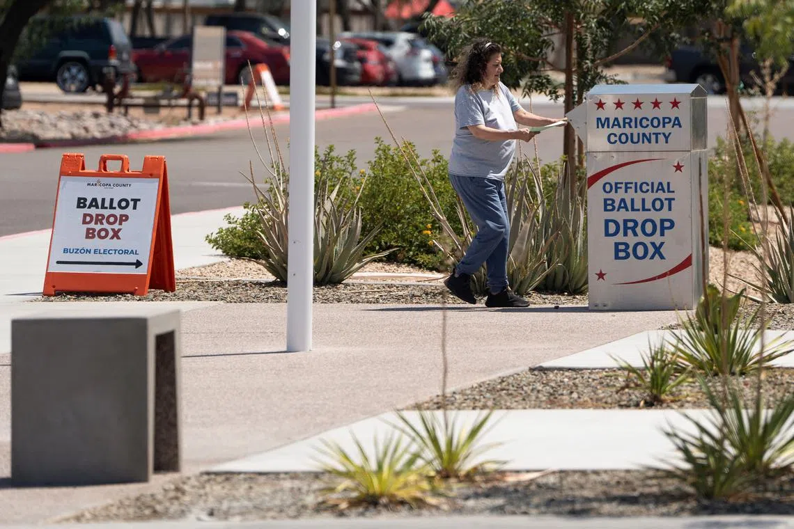 A voter casting their mail-in ballot at a ballot drop box outside Maricopa County Recorder and Elections Department during the Arizona state primary election in on July 30, 2024. REUTERS/Rebecca Noble/File Photo
