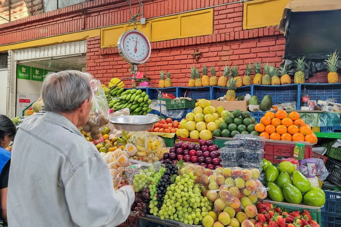 FILE PHOTO: A person sells food in a market square in Bogota, Colombia, December 1, 2024. REUTERS/Luis Jaime Acosta/File Photo
