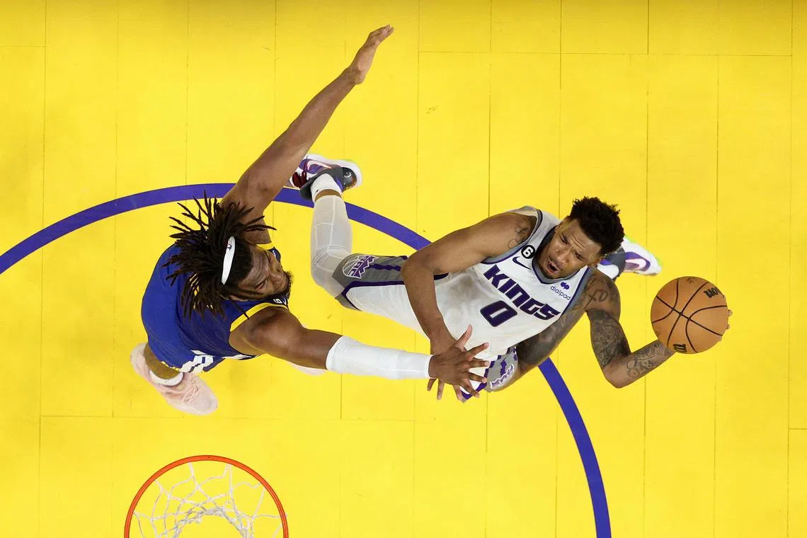 Malik Monk of the Sacramento Kings goes up for a shot on Kevon Looney of the Golden State Warriors during Game 6 of their NBA Western Conference play-offs.