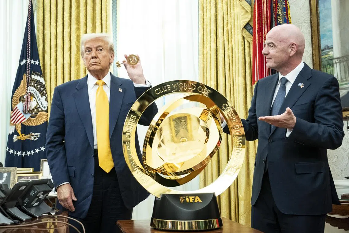 US President Donald Trump (left) and Fifa president Gianni Infantino with the Fifa Club World Cup trophy. Mr Trump signed an executive order to establish a task force to prepare for the Fifa 2026 World Cup, which the US is co-hosting.