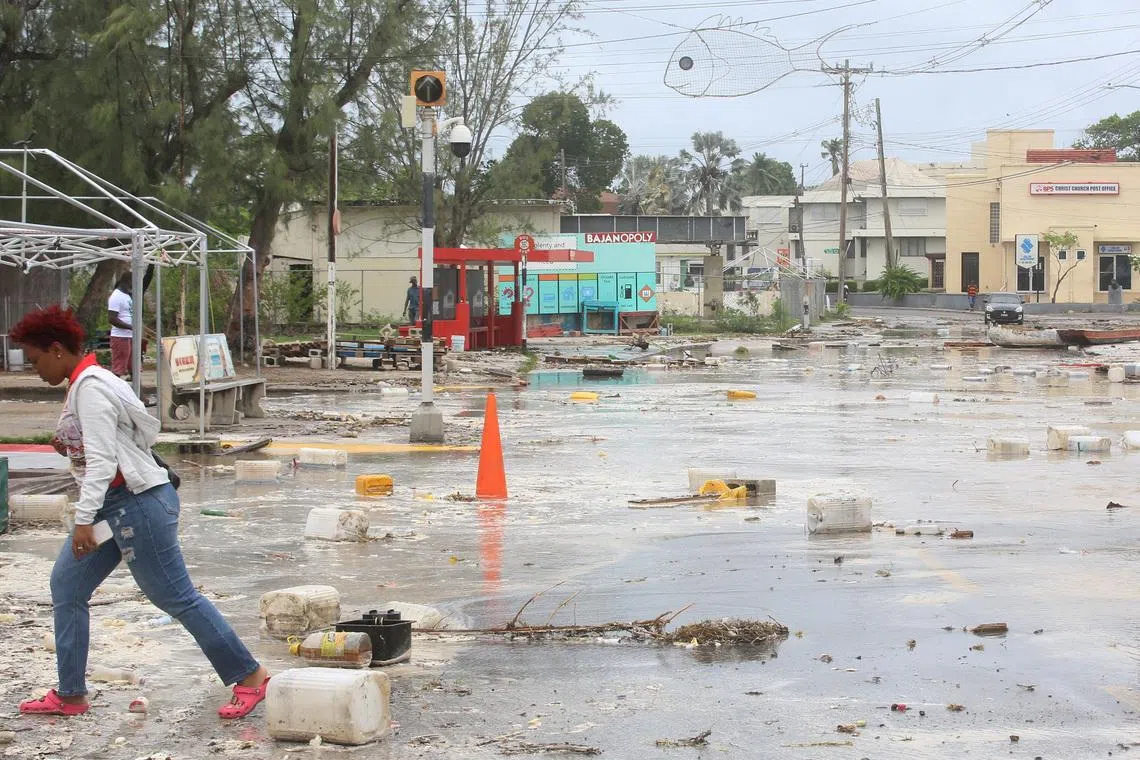 A woman walks through a debris filled street in the Hastings neighborhood after Hurricane Beryl passed in Bridgetown, Barbados July 1, 2024.  REUTERS/Nigel R Browne/File Photo