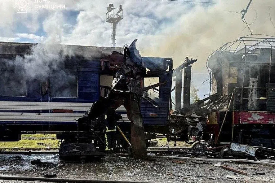 Smoke rising over a passenger train hit by a Russian drone strike in Shostka, in Ukraine's Sumy region, on Oct 4.