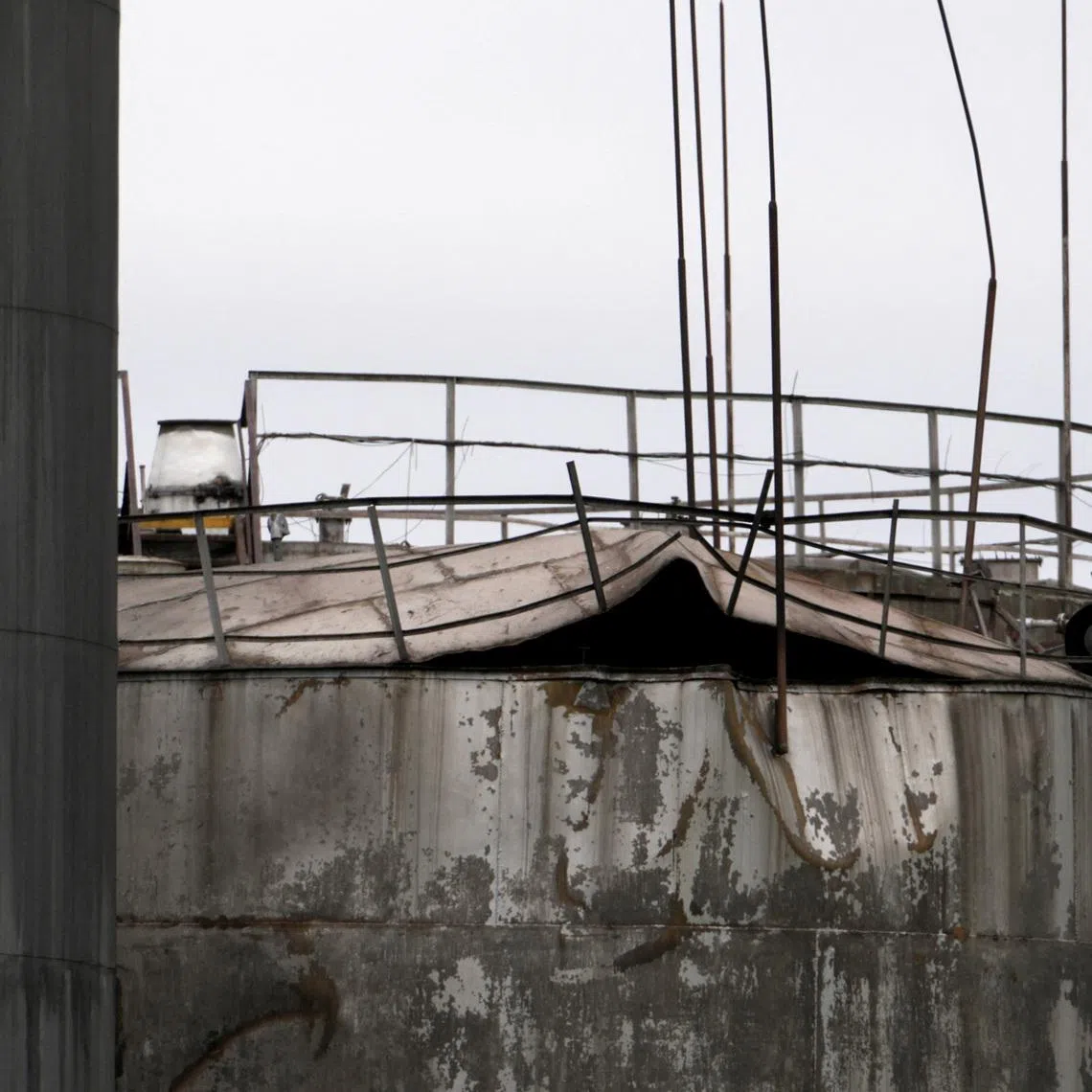 Damage to an oil tank after drones crashed at a storage facility in Rezekne, Latvia, May 7, 2026. REUTERS/Janis Laizans