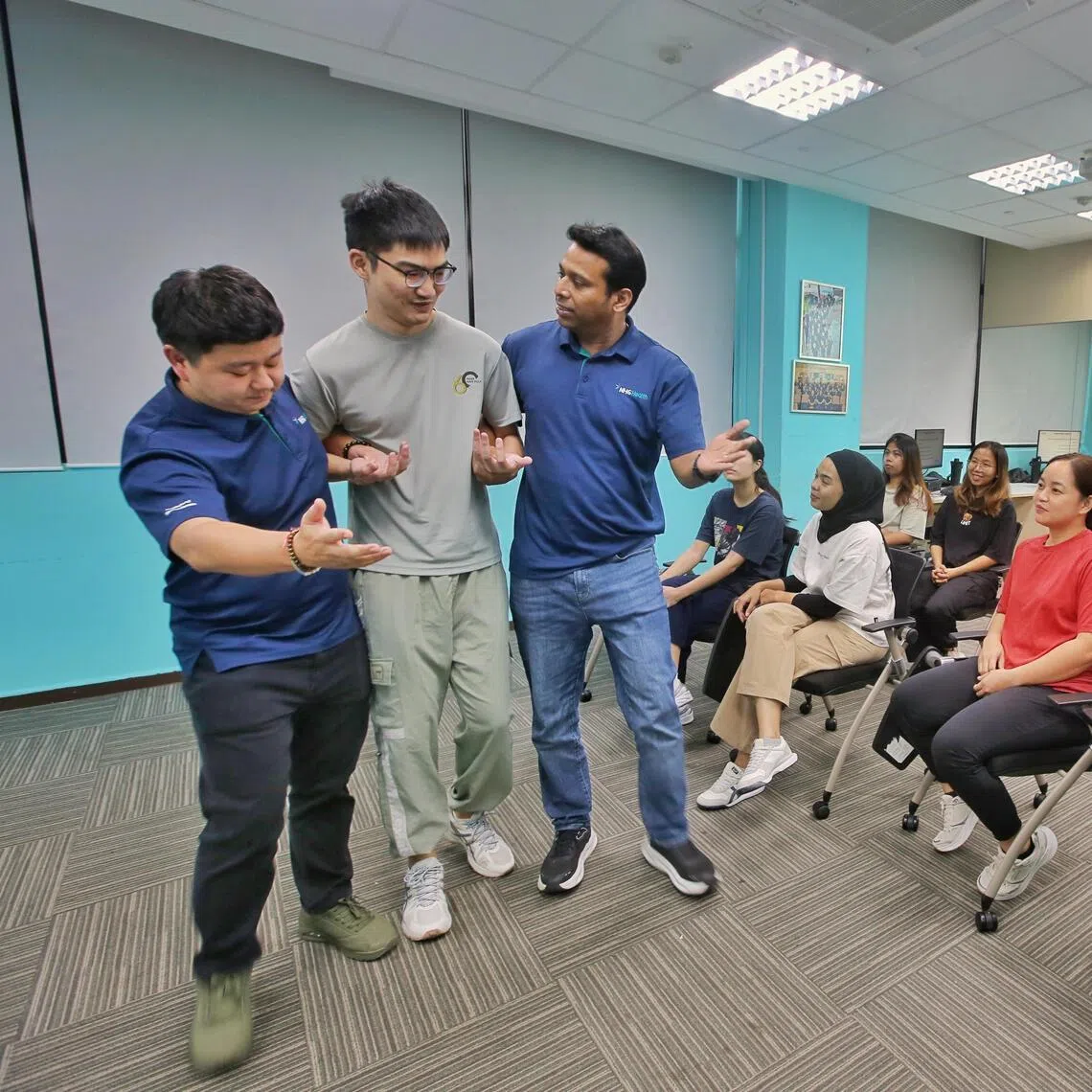 IMH senior nurse manager Win Min Htet (left) and assistant director of nursing Kalaivanan Dakshnamoorthy (third from left) developed the Code Grey training programme.
