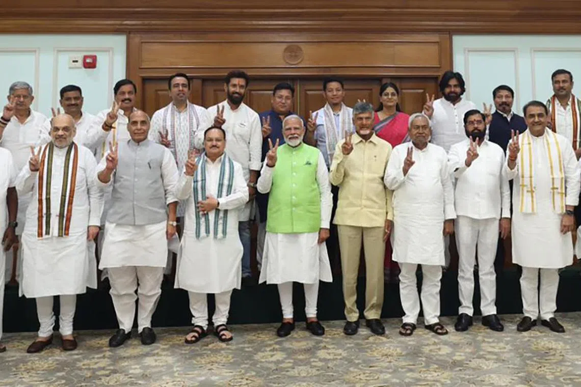 Prime Minister Narendra Modi with leaders of the National Democratic Alliance and his own party, at his residence in New Delhi on June 5.
