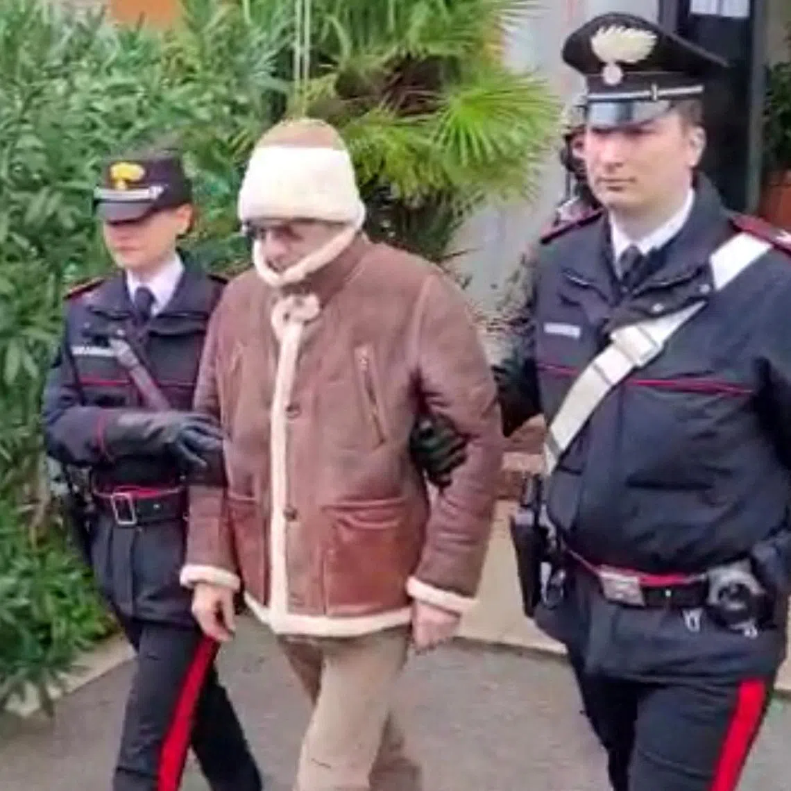 FILE PHOTO: A screengrab taken from a video shows Matteo Messina Denaro the country's most wanted mafia boss being escorted out of a Carabinieri police station after he was arrested in Palermo, Italy, January 16, 2023. Carabinieri/Handout via REUTERS/File Photo
