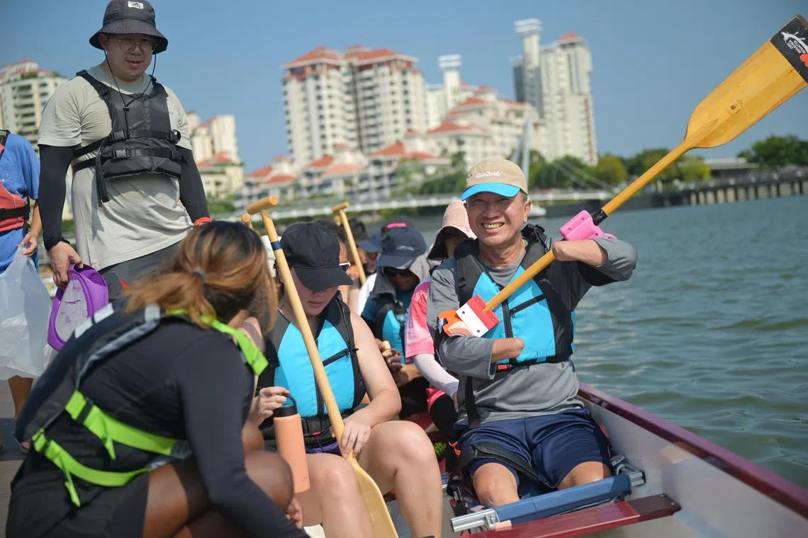 Mr Tan Whee Boon (right), 59, a quad amputee, in a dragon boat at Water Sports Centre to train for Pesta Sukan on July 20.  ST PHOTO: AZMI ATHNI