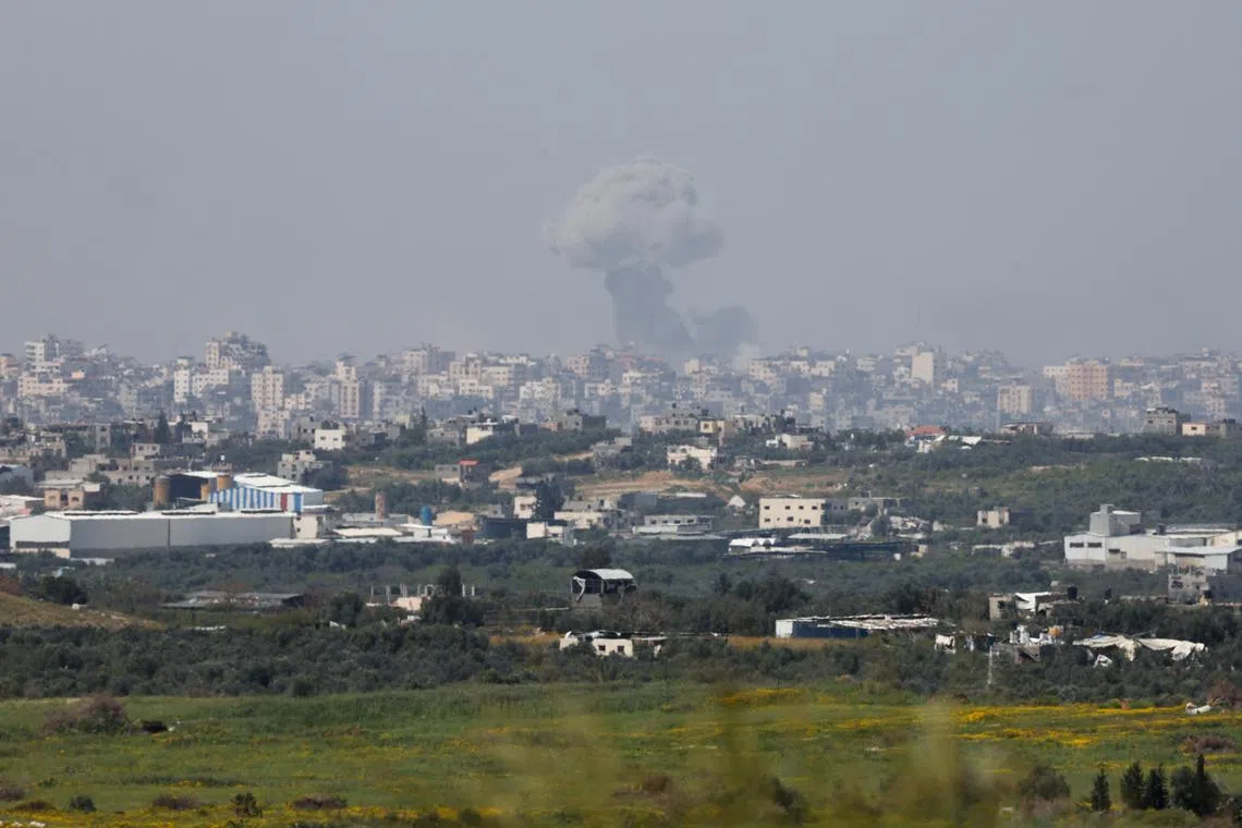 Smoke rises over Gaza following an explosion, amid the ongoing conflict between Israel and the Palestinian Islamist group Hamas, as seen from Israel, March 27, 2024. REUTERS/Ronen Zvulun/ File photo