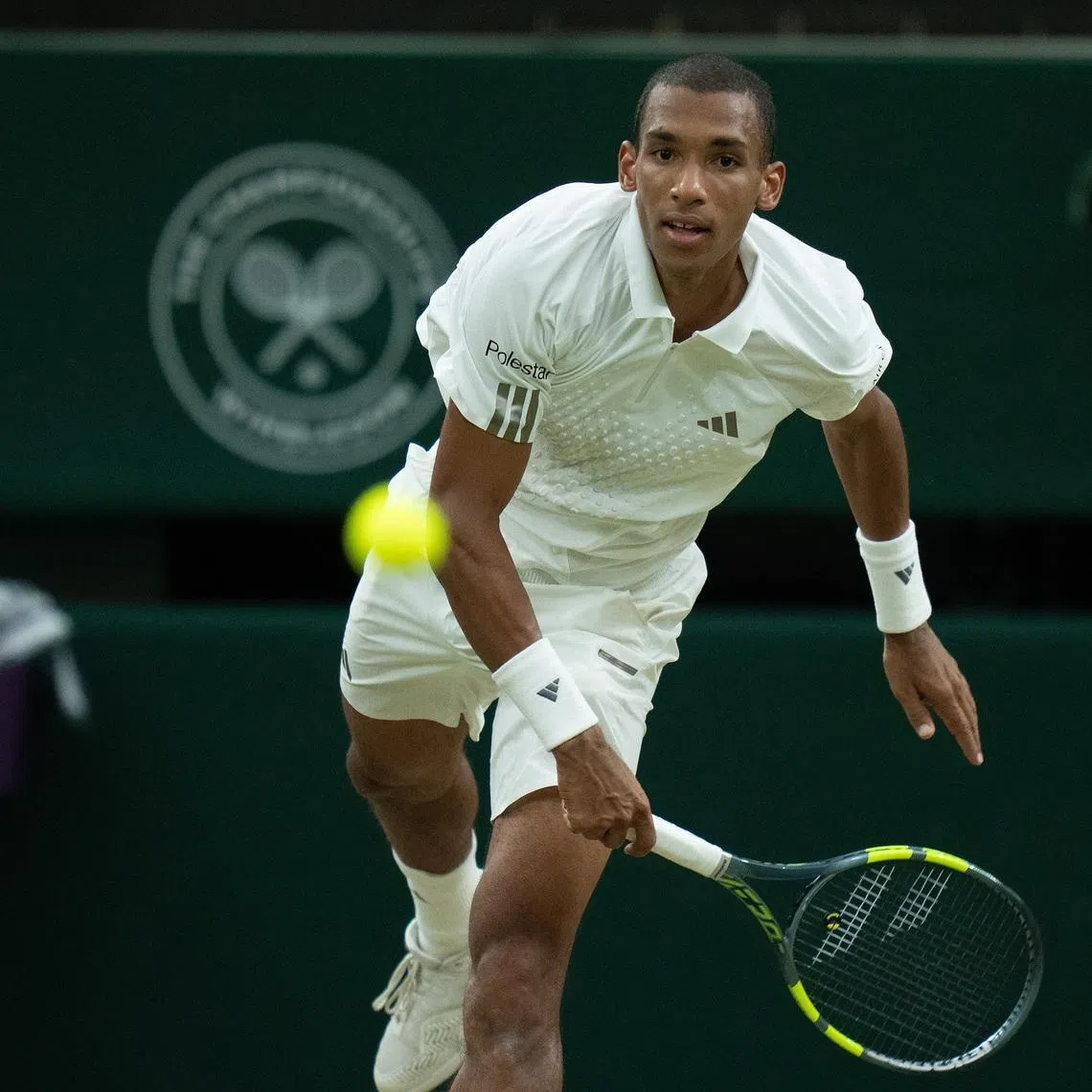 Jul 7, 2026; London, United Kingdom; Felix Auger-Aliassime of Canada serves the ball during his match against Novak Djokovic of Serbia on day nine at All England Lawn Tennis and Croquet Club.  Mandatory Credit: Susan Mullane-Imagn Images