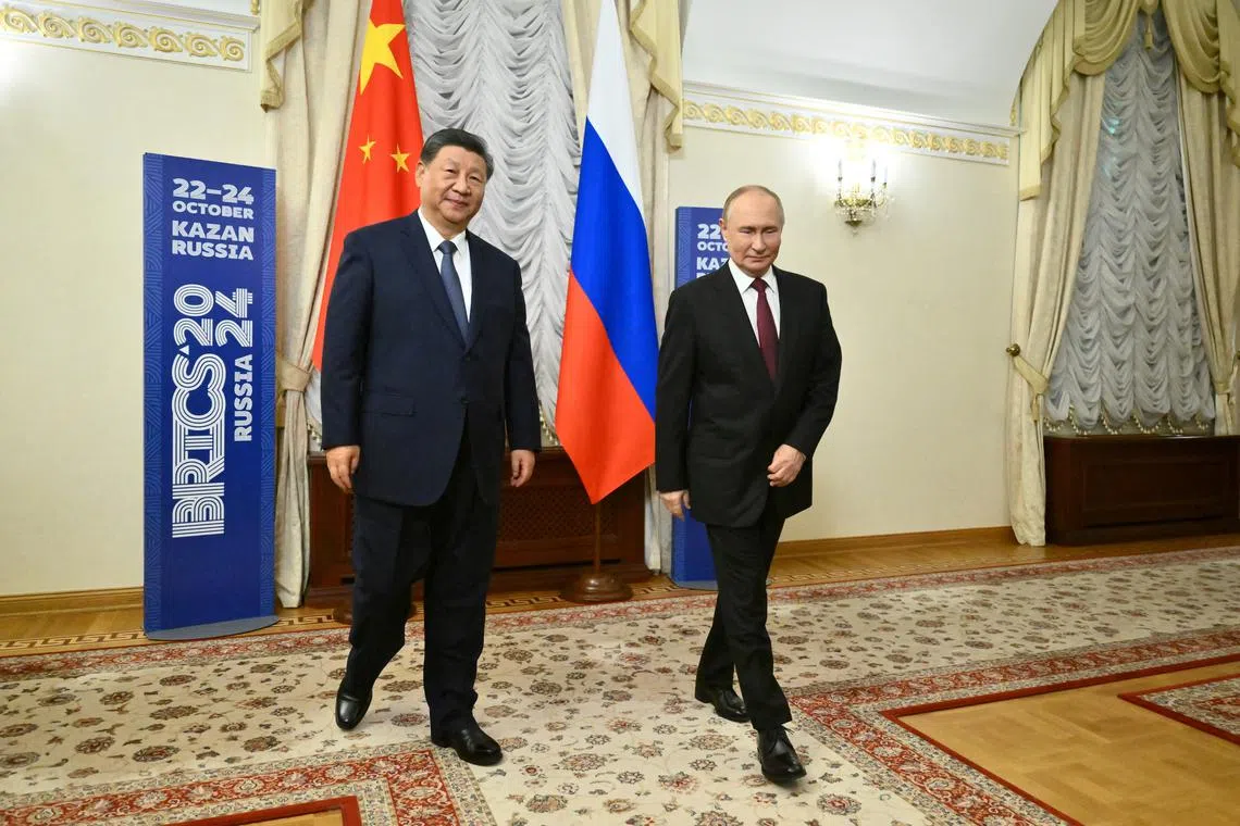 Russian President Vladimir Putin and Chinese President Xi Jinping walk during a meeting on the sidelines of the BRICS Summit in Kazan, Russia October 22, 2024. Kristina Kormilitsyna/BRICS-RUSSIA2024.RU Host Photo Agency via REUTERS