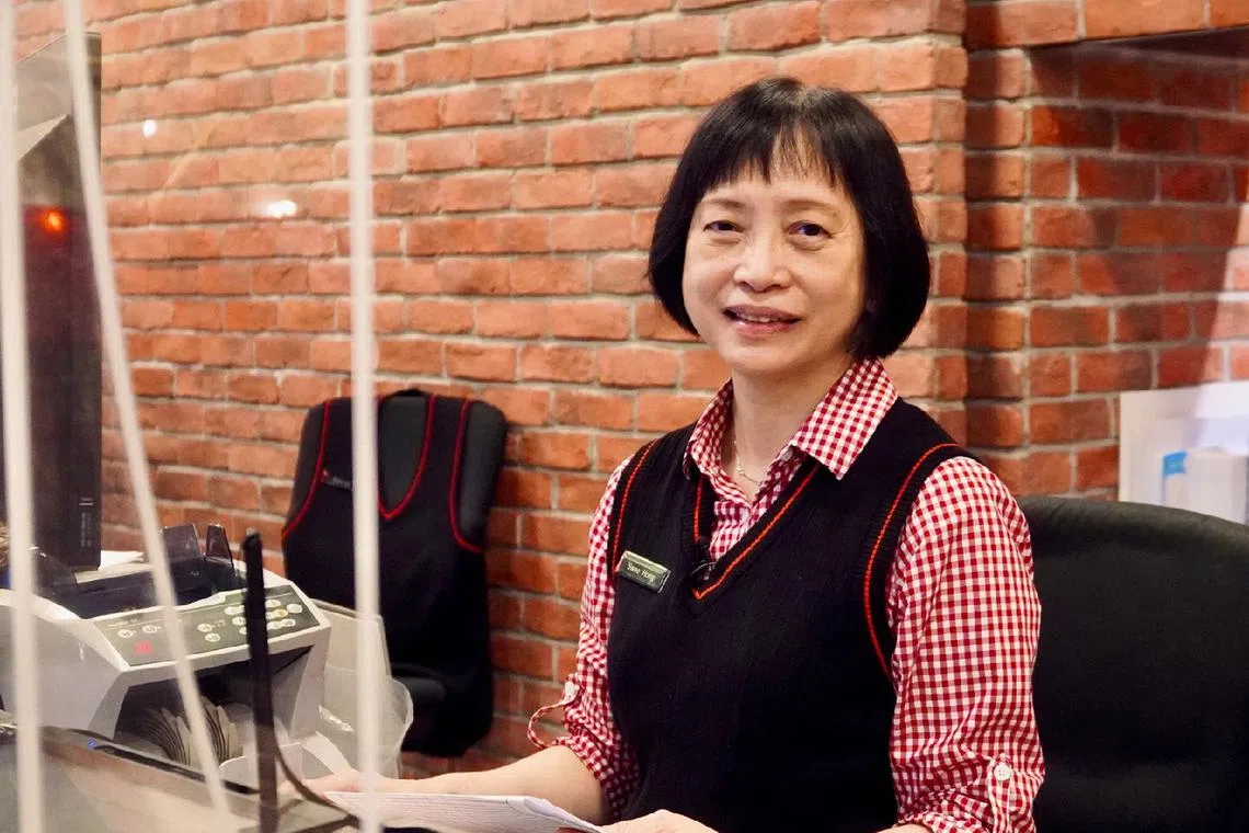 DBS bank teller Loo Swee Hong suspected something was amiss when she saw the $10,000 notes, which have not been in circulation since 2014.